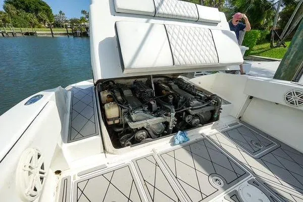 Slide: The Image of 2007 Spectre 37 Center Console boat engine compartment with open hatch, dockside view. - 23