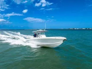 Slide: The Image of 2007 Spectre 37 Center Console boat cruising on open water under clear blue skies. - 3