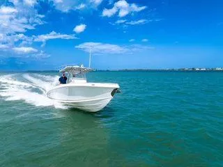 Slide: The Image of 2007 Spectre 37 Center Console boat cruising on open water under blue sky. - 4