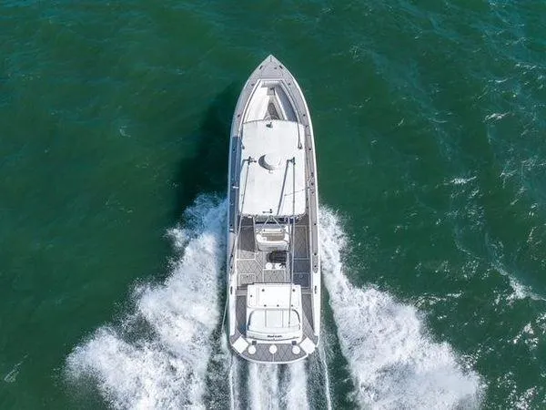 Slide: The Image of 2007 Spectre 37 Center Console boat cruising on open water, aerial view. - 5