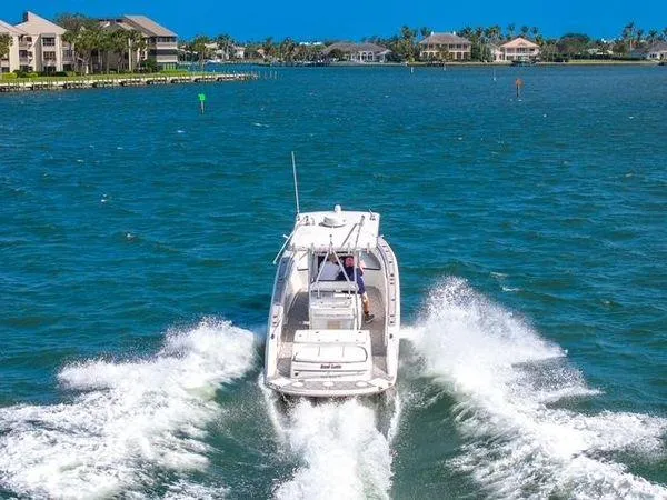 Slide: The Image of 2007 Spectre 37 Center Console boat cruising on a sunny day in a coastal area. - 6