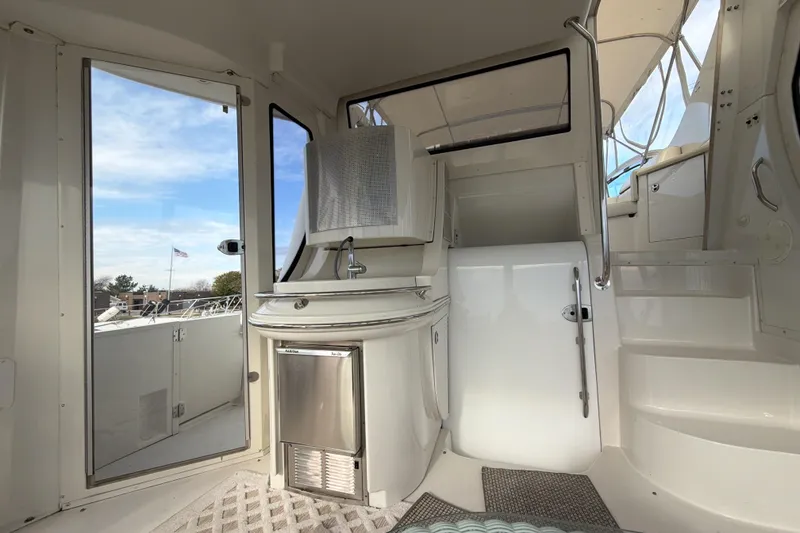 Slide: The Image of 2003 Carver 564 Cockpit Motor Yacht interior with sink and outdoor view. - 17