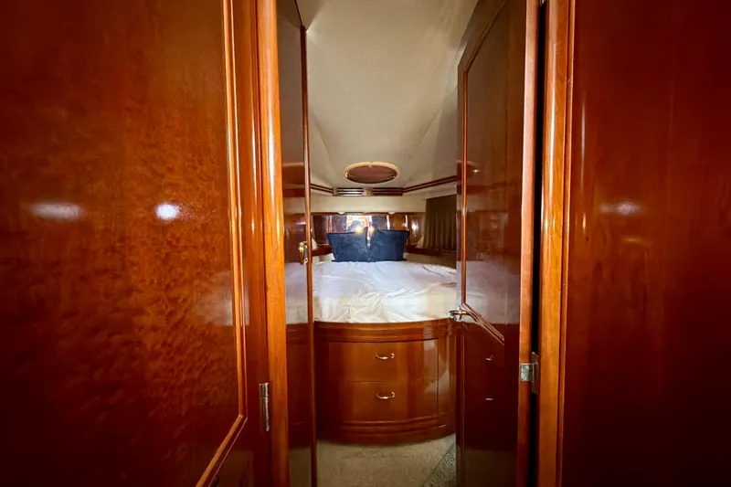 Slide: The Image of Luxurious bedroom interior of 2003 Carver 564 Cockpit Motor Yacht with wooden finish. - 32
