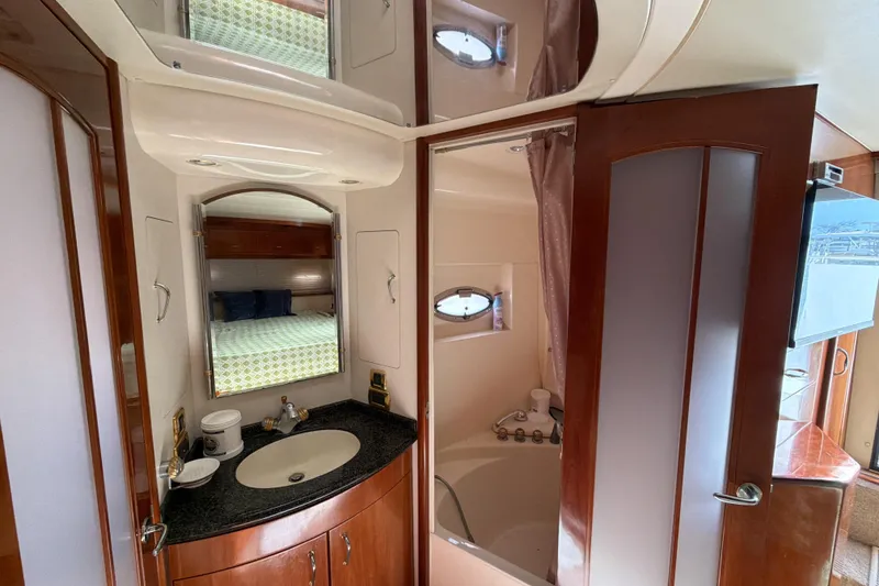 Slide: The Image of Luxurious bathroom interior of 2003 Carver 564 Cockpit Motor Yacht with sink and shower. - 44