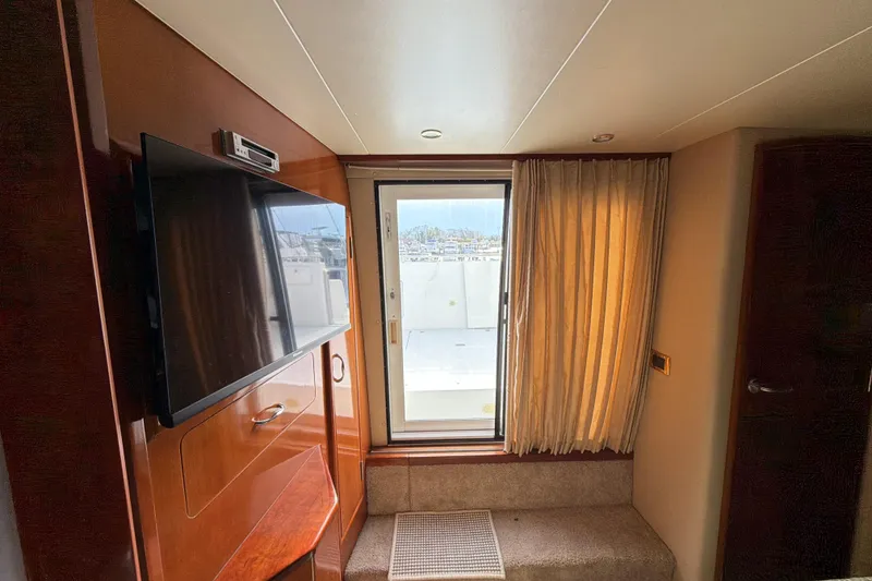 Slide: The Image of Interior of 2003 Carver 564 Cockpit Motor Yacht with TV and window view. - 45