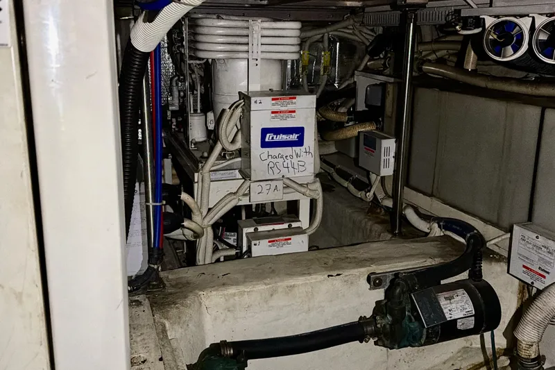 Slide: The Image of Engine room of 2003 Carver 564 Cockpit Motor Yacht with mechanical equipment and wiring. - 51