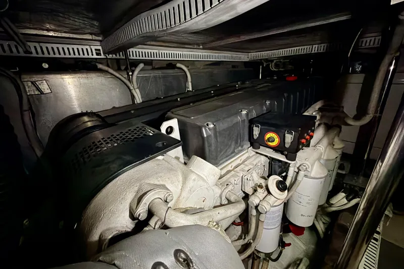 Slide: The Image of Engine room of a 2003 Carver 564 Cockpit Motor Yacht, showcasing mechanical components. - 53