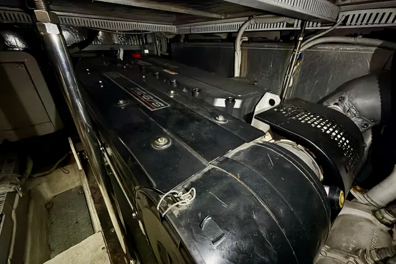 Slide: The Image of Engine room of 2003 Carver 564 Cockpit Motor Yacht, showcasing mechanical components. - 54