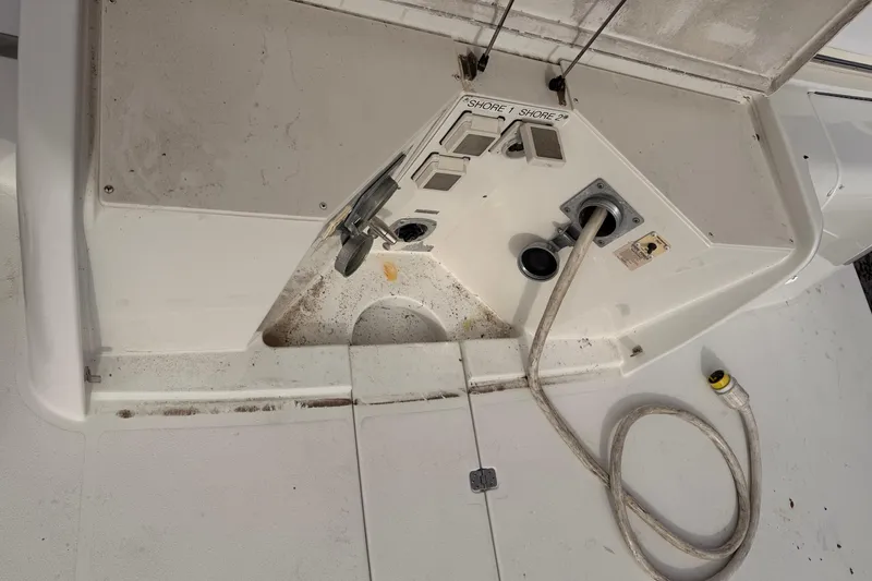 Slide: The Image of 2003 Carver 564 Cockpit Motor Yacht shore power connections and cables. - 6