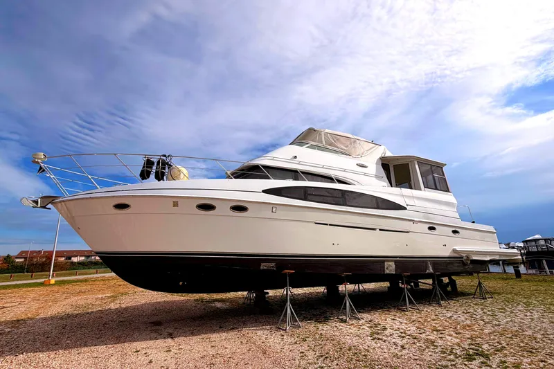 The Image of 2003 Carver 564 Cockpit Motor Yacht on blue ocean under clear sky. - 0