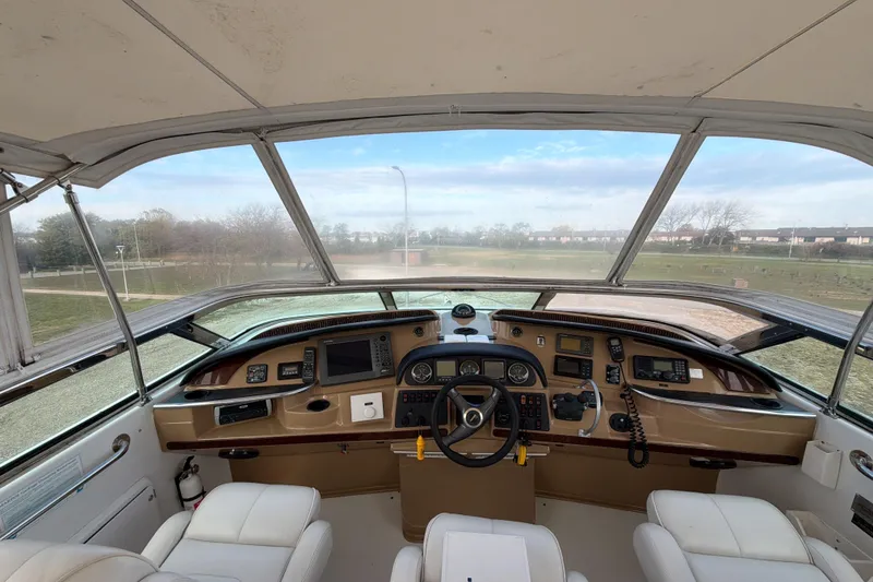 Slide: The Image of 2003 Carver 564 Cockpit Motor Yacht helm with navigation instruments and panoramic view. - 14