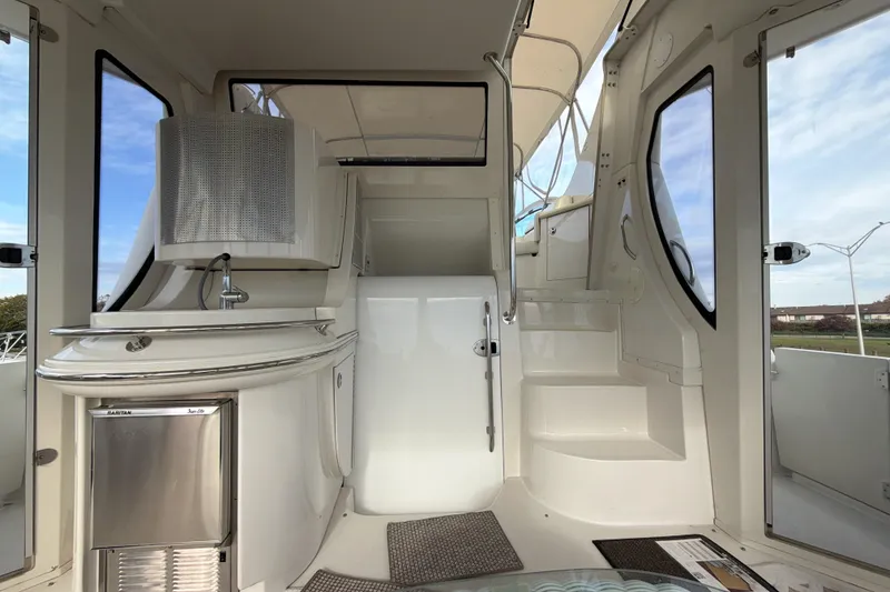 Slide: The Image of 2003 Carver 564 Cockpit Motor Yacht interior with kitchenette and stairs. - 19