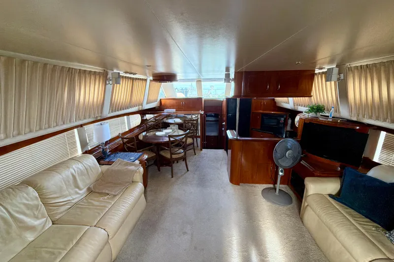 Slide: The Image of Luxurious interior of 2003 Carver 564 Cockpit Motor Yacht with leather seating and dining area. - 24