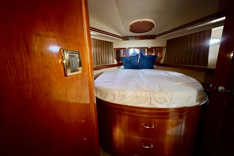 Slide: The Image of Luxurious bedroom interior of 2003 Carver 564 Cockpit Motor Yacht with wood finish. - 34