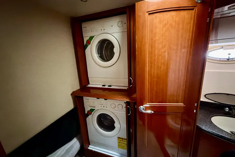 Slide: The Image of Laundry area with stacked washer and dryer in 2003 Carver 564 Cockpit Motor Yacht. - 40