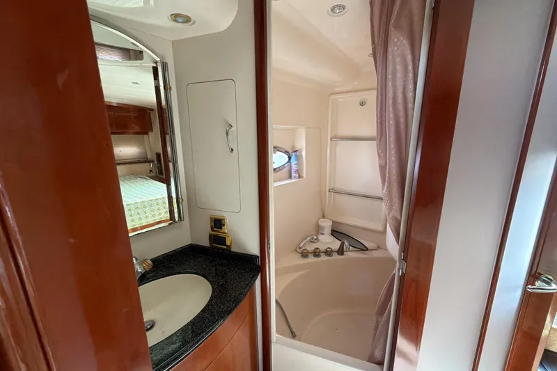 Slide: The Image of Bathroom interior of 2003 Carver 564 Cockpit Motor Yacht with sink and shower. - 42