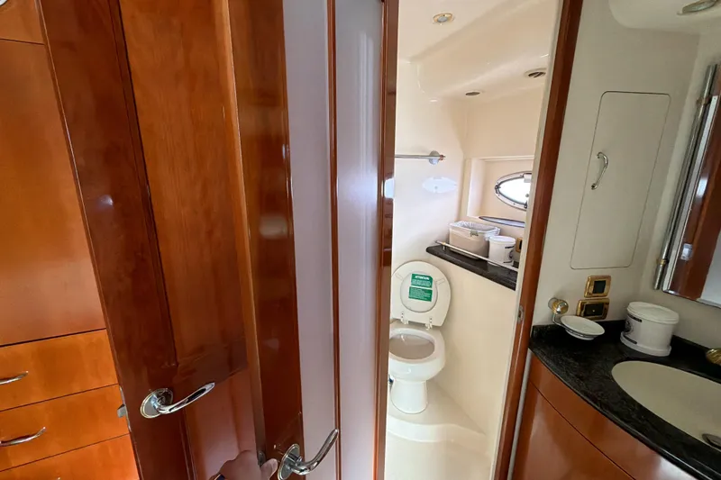 Slide: The Image of Interior of 2003 Carver 564 Cockpit Motor Yacht bathroom with wooden cabinetry. - 43