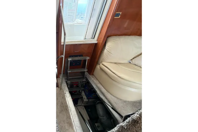 Slide: The Image of Interior view of 2003 Carver 564 Cockpit Motor Yacht with open engine access. - 46