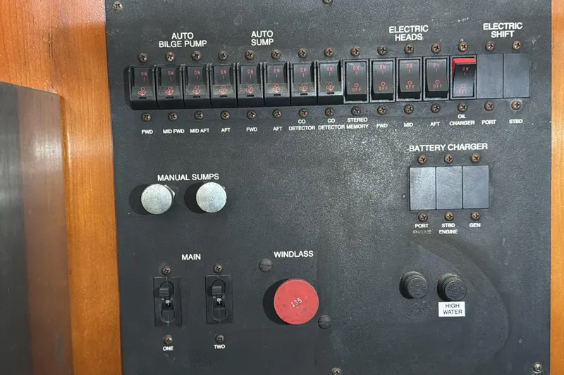 Slide: The Image of Control panel of a 2003 Carver 564 Cockpit Motor Yacht with switches and dials. - 47