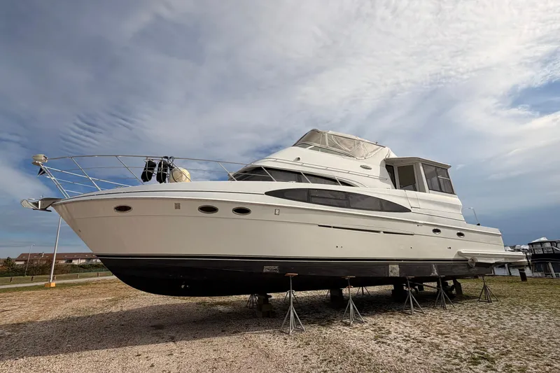 Slide: The Image of 2003 Carver 564 Cockpit Motor Yacht docked at marina under cloudy sky. - 8