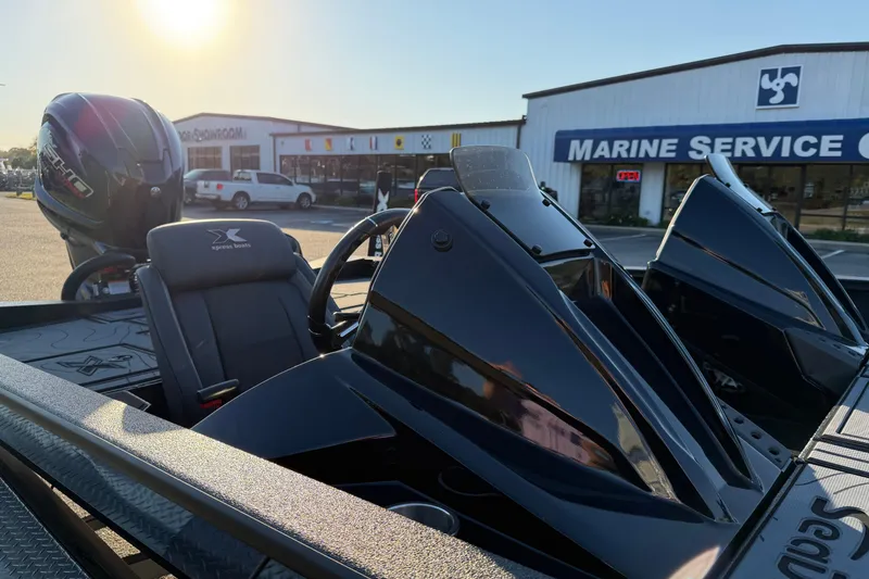 Slide: The Image of Xpress X21 Pro 2025 boat at marine service center, with sleek black design and powerful engine. - 11
