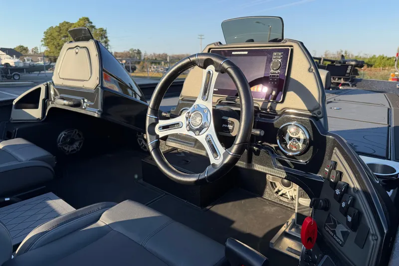 Slide: The Image of Interior view of 2025 Xpress X21 Pro boat with modern steering and dashboard. - 12