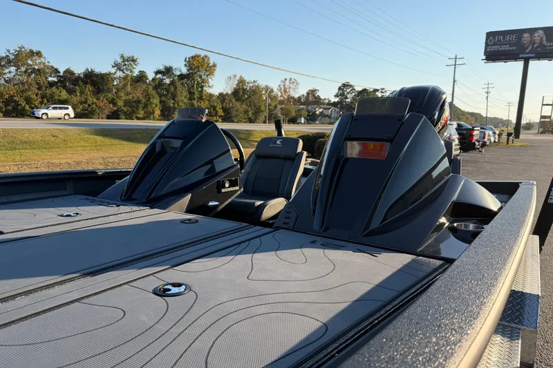 Slide: The Image of 2025 Xpress X21 Pro boat with dual engines, parked near a road under clear skies. - 14