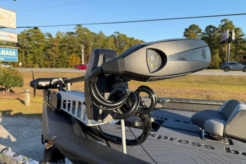 Slide: The Image of Trolling motor on 2025 Xpress X21 Pro boat, parked outdoors on a sunny day. - 15