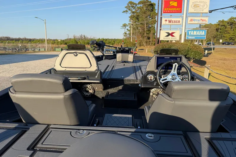 Slide: The Image of Interior view of 2025 Xpress X21 Pro boat with modern dashboard and seating. - 16