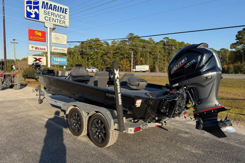 Slide: The Image of 2025 Xpress X21 Pro boat on trailer at Marine Service Center. - 3