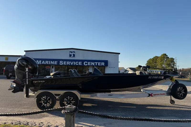 Slide: The Image of 2025 Xpress X21 Pro boat on trailer outside Marine Service Center. - 4