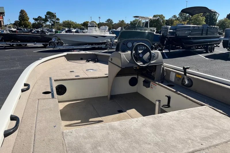 Slide: The Image of 2008 Fisher 160 Pro Avenger SC boat interior with steering console, parked outdoors. - 5