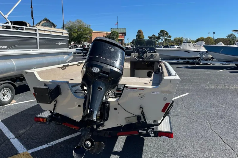 Slide: The Image of 2008 Fisher 160 Pro Avenger SC boat with outboard motor in a parking lot. - 6