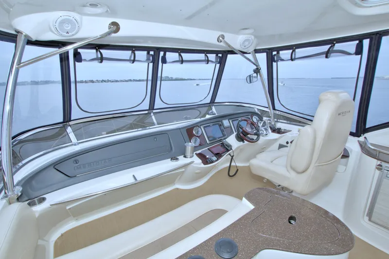 Slide: The Image of Interior of 2013 Meridian 441 Sedan yacht cockpit with panoramic windows and modern controls. - 16