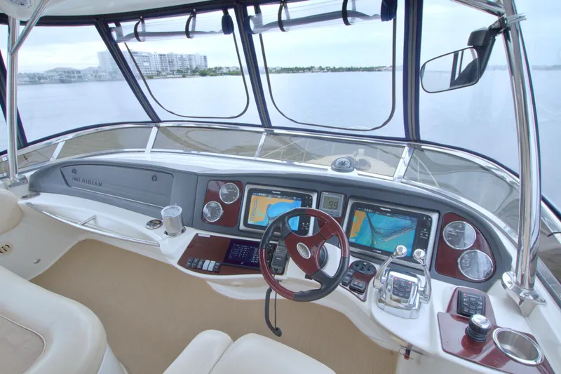 Slide: The Image of 2013 Meridian 441 Sedan yacht helm with navigation screens and controls. - 18