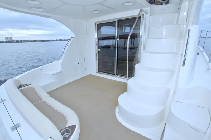 Slide: The Image of 2013 Meridian 441 Sedan yacht interior with stairs and seating, overlooking water. - 23