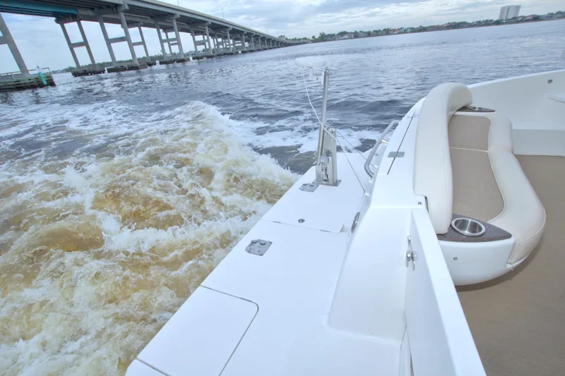 Slide: The Image of 2013 Meridian 441 Sedan cruising under a bridge, featuring a spacious deck and seating area. - 25
