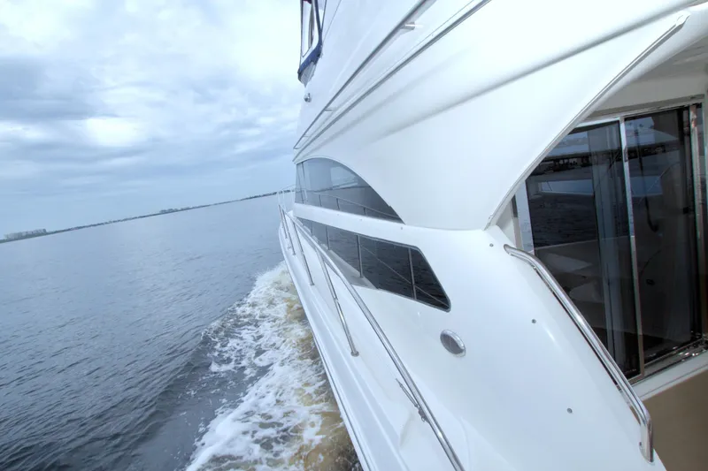 Slide: The Image of 2013 Meridian 441 Sedan yacht cruising on calm waters under cloudy skies. - 26