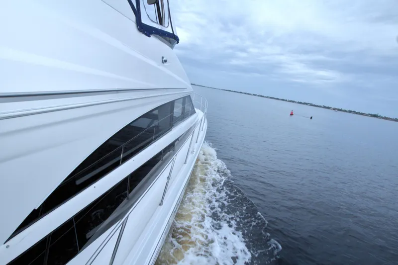 Slide: The Image of 2013 Meridian 441 Sedan yacht cruising on calm waters under cloudy skies. - 28
