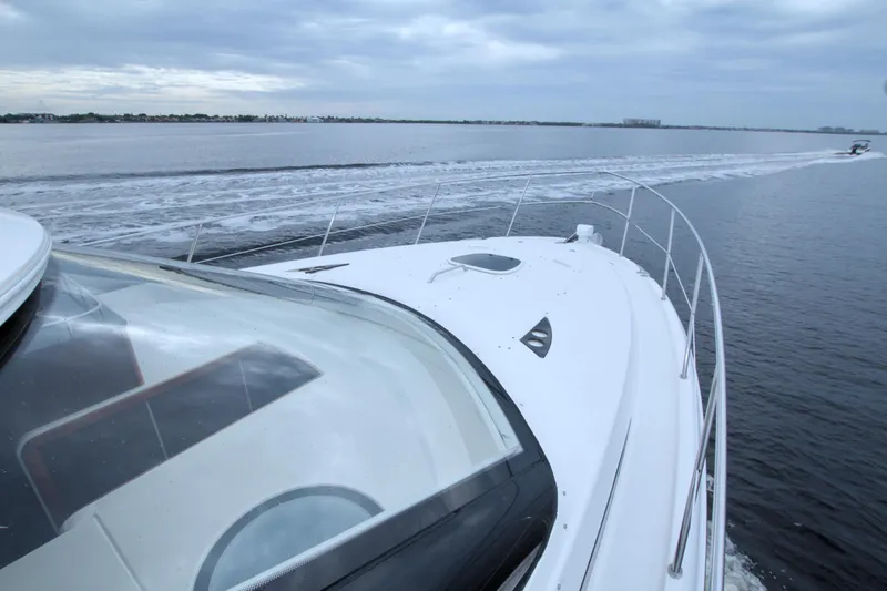 Slide: The Image of 2013 Meridian 441 Sedan yacht cruising on open water under cloudy skies. - 29