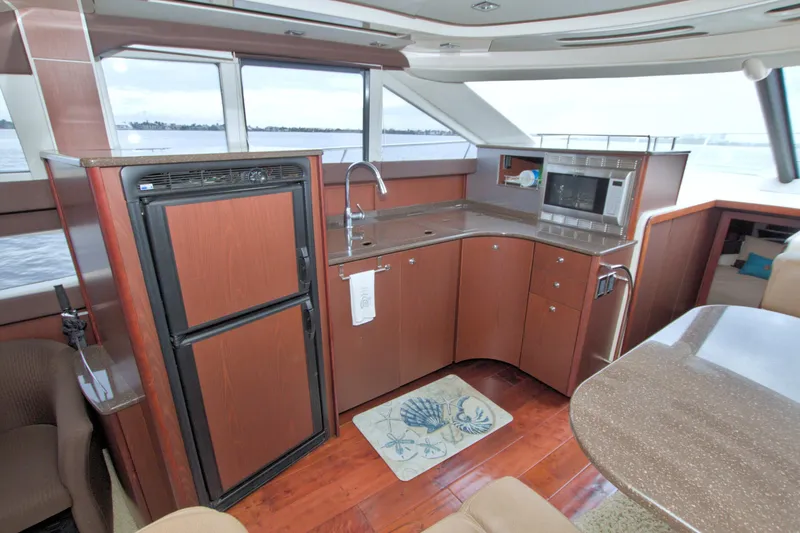 Slide: The Image of Luxurious 2013 Meridian 441 Sedan yacht kitchen with modern appliances and elegant wood finish. - 41