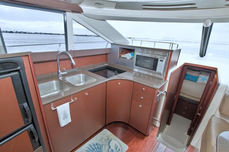 Slide: The Image of Luxurious 2013 Meridian 441 Sedan yacht kitchen with modern amenities and scenic water view. - 42