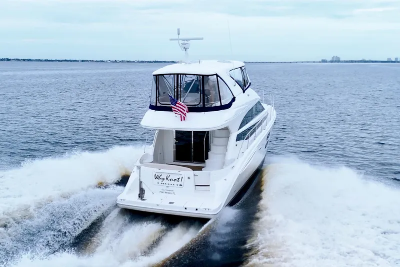 Slide: The Image of 2013 Meridian 441 Sedan yacht cruising on open water, rear view with wake. - 5
