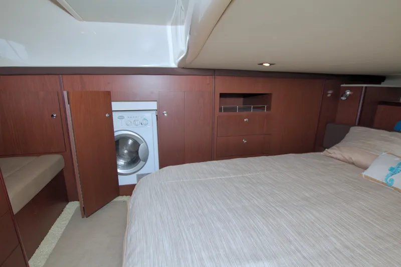 Slide: The Image of 2013 Meridian 441 Sedan interior with bed, wood cabinetry, and built-in washing machine. - 52