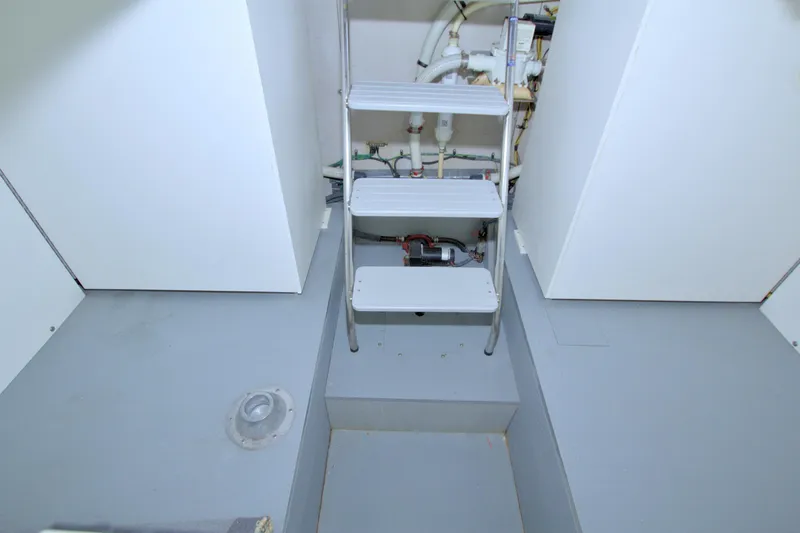 Slide: The Image of Engine room of 2013 Meridian 441 Sedan with ladder and visible piping. - 63