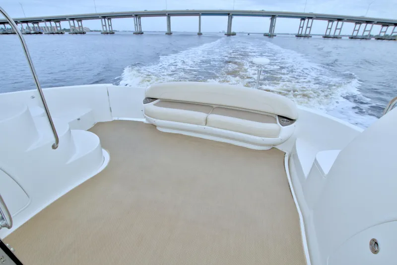 Slide: The Image of 2013 Meridian 441 Sedan yacht deck with seating, cruising under a bridge. - 70
