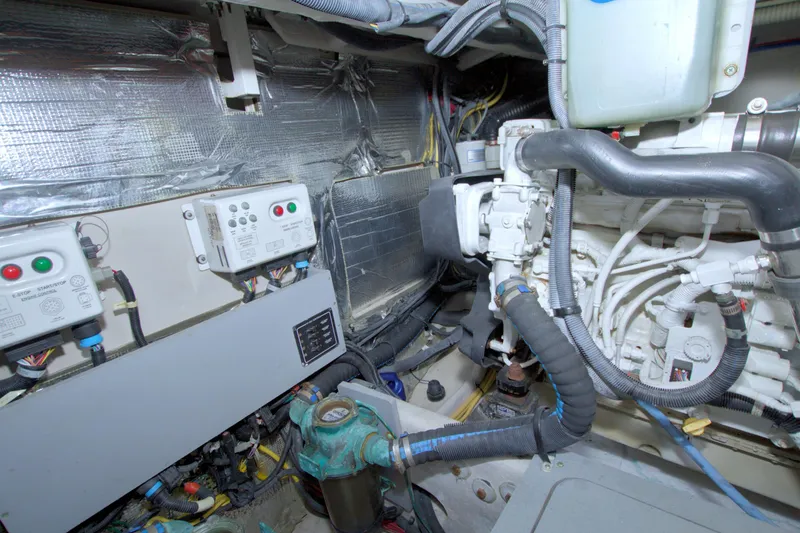 Slide: The Image of Engine room of a 2013 Meridian 441 Sedan yacht, showcasing mechanical components and wiring. - 77