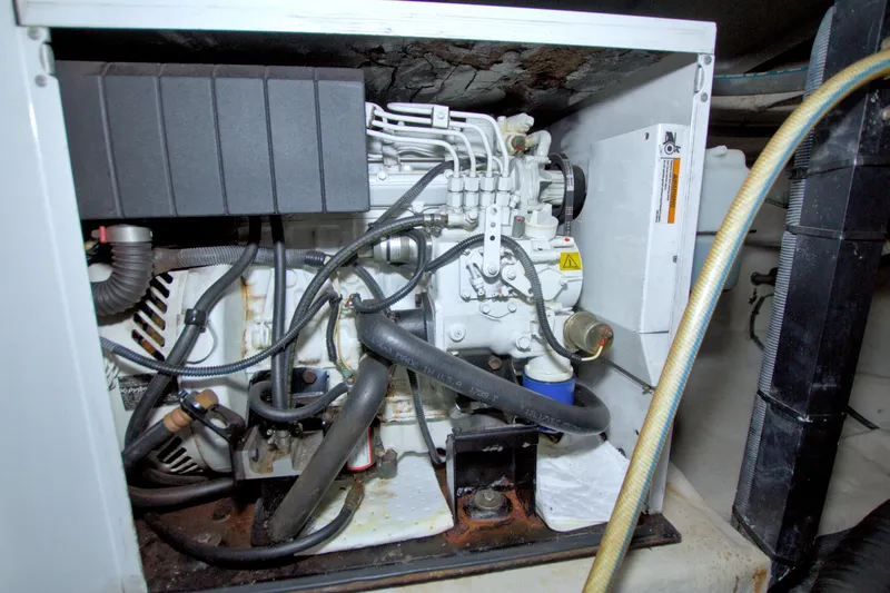 Slide: The Image of Engine compartment of a 2013 Meridian 441 Sedan yacht, showcasing mechanical components and hoses. - 90