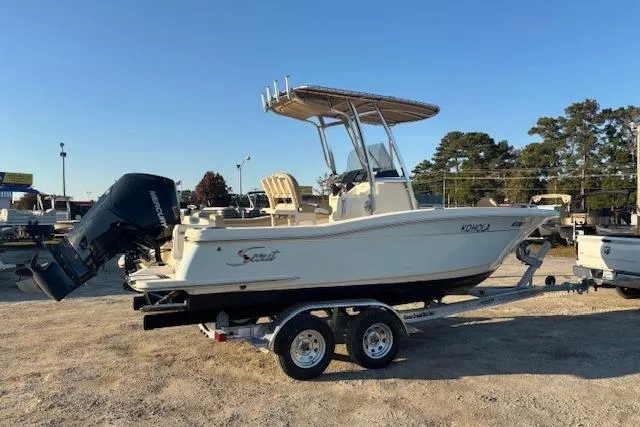 The Image of 2022 Scout 215 XSF boat on trailer, parked outdoors, side view. - 1