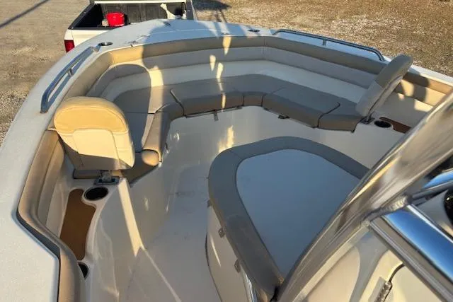 Slide: The Image of 2022 Scout 215 XSF boat interior with cushioned seating and cup holders. - 10